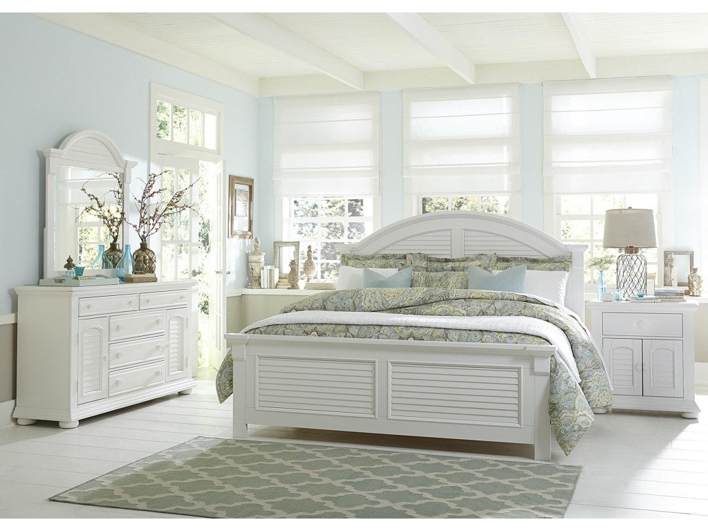 {'index': 4, 'type': 'main', 'description': 'Clear, detailed front-angle view of the white nightstand, prominently showcasing its single drawer, louvered cabinet door, and bun feet alongside the bed.'}